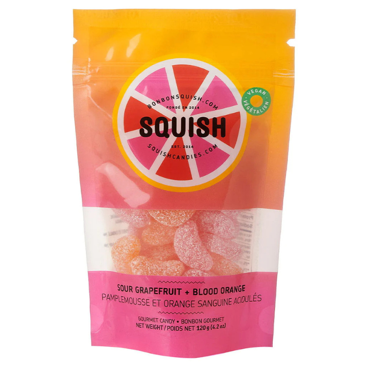 Sac de bonbon vegan à la saveur de pamplemousse et orange sanguine acidulés la marque squish sur un Un fond blanc. Vendu par Eco Loco, Le sac est orangé et rose.
