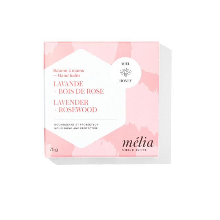 Boite rose et blanche sur laquelle on peut lire en francais et en anglais mélia miels d'anicet baume à mains lavande bois de rose nourrissant et protecteur, miel. 