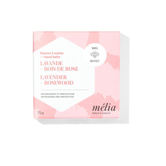 Boite rose et blanche sur laquelle on peut lire en francais et en anglais mélia miels d'anicet baume à mains lavande bois de rose nourrissant et protecteur, miel. 