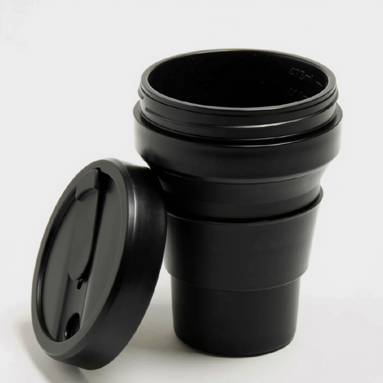 tasse café réutilisable Stojo rétractable en silicone de couleur noire et son couvercle  sur fond blanc